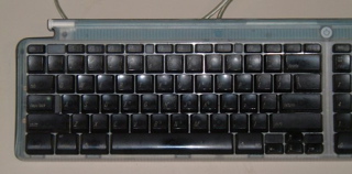 A standard Bondi-blue iMac QWERTY keyboard